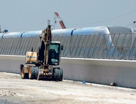 A digger sits next to the Dubai Metro line as construction pushes forward for completion of the red line.