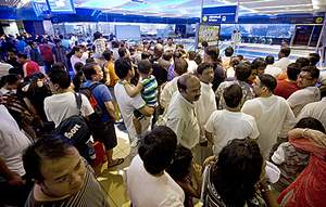 A queue of passengers waits to go through the boarding turnstiles at the Khalid Bin Al Waleed station yesterday. Jeff Topping / The National