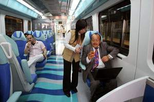 Patricio Porras, an expat from Ecuador speaks with Shuang Li, from China, a train attendant, on board the first train of the day on the Dubai Metro. (Randi Sokoloff / The National)