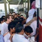     *  Passengers scramble to board a bus at Al Ghubaiba Bus Station.