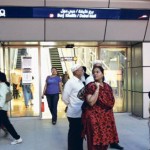     *  Commuters wait outside the Burj Khalifa Metro Station during a disruption in the service yesterday.