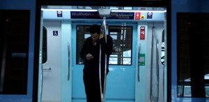 A man riding the Dubai Metro at the Al Karama Station is probably checking his e-mails, but I bet he'd rather be surfing the Web on his mobile. Pawan Singh / The National