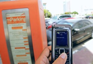     *  A motorist uses the mParking service by sending an SMS through his mobile phone at a paid parking zone on Shaikh Zayed road.     * Image Credit: Virendra Saklani/Gulf News