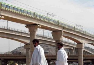     *  A Makkah Metro train passes over pilgrims’ heads. The first phase of the Makkah Metro project is transporting pilgrims between the cities of Mina, Arafat and Muzdalifa.     * Image Credit: AP