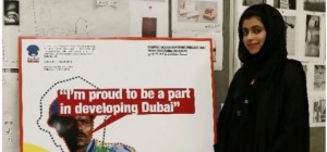 Emirati Hessa al Hasshimi, 21, a graduating graphic design student with one of her posters at Zayed University.