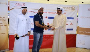 Sultan Al Marzouqi receives the best player award from Dr. Ahmed Al Sharif general secretary of DSC while Nasser Al Rahma also from DSC, looks on. (SUPPLIED)