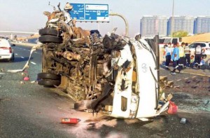 Image Credit: Courtesy: Dubai Police The wreckage of an overturned bus after the accident on Emirates Road on Saturday. The bus collided with a truck, killing 13 people and injuring 15.