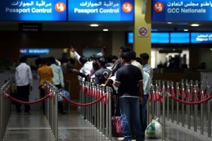 People wait in line at the passport control area in Terminal 1 arrivals section at the Dubai International airport. Tens of thousands of passengers are expected to travel through Dubai airport this week. Randi Sokoloff / The National