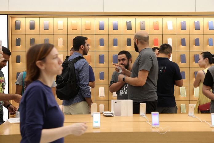 Customers shop at the Apple store in Dubai during the launch of the iPhone 7 at Mall of the Emirates. Pawan Singh / The National