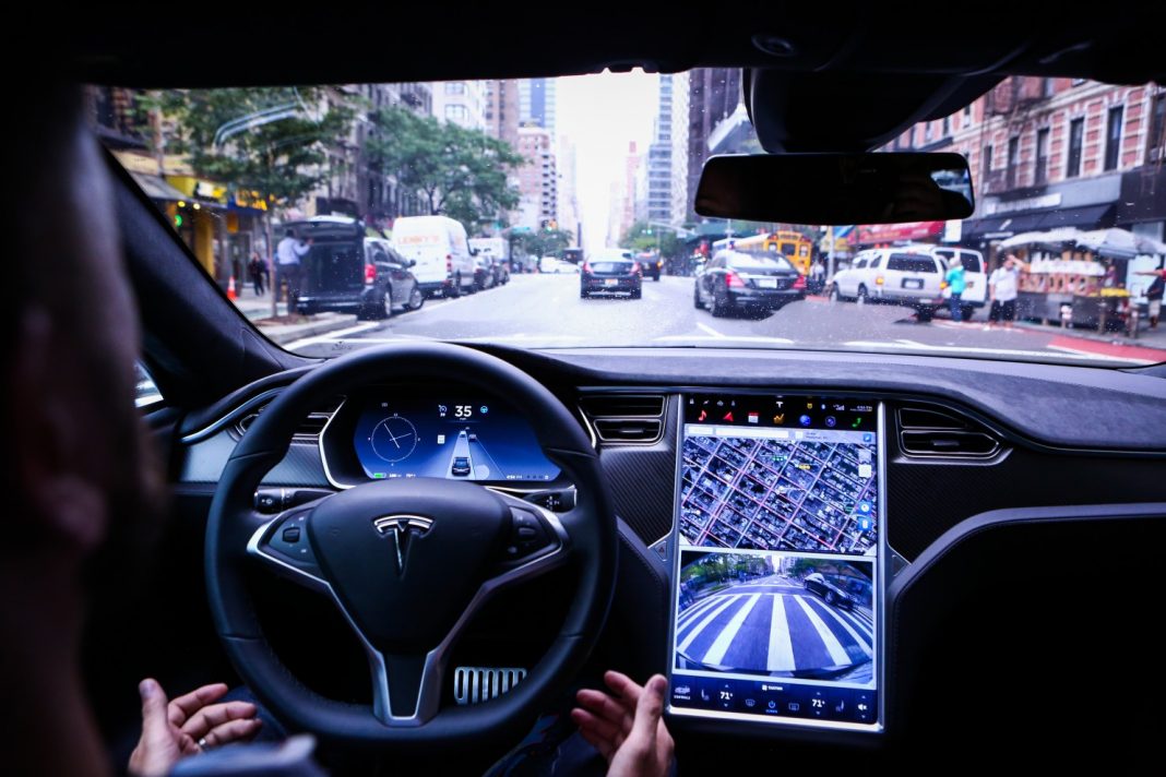 A driver rides hands-free in a Tesla Model S equipped with Autopilot hardware and software in New York on Sept. 19. California says a true autonomous vehicle is one that is “equipped with technology that has the capability of operating or driving the vehicle without the active physical control or monitoring of a natural person.” (Christopher Goodney/Bloomberg News)